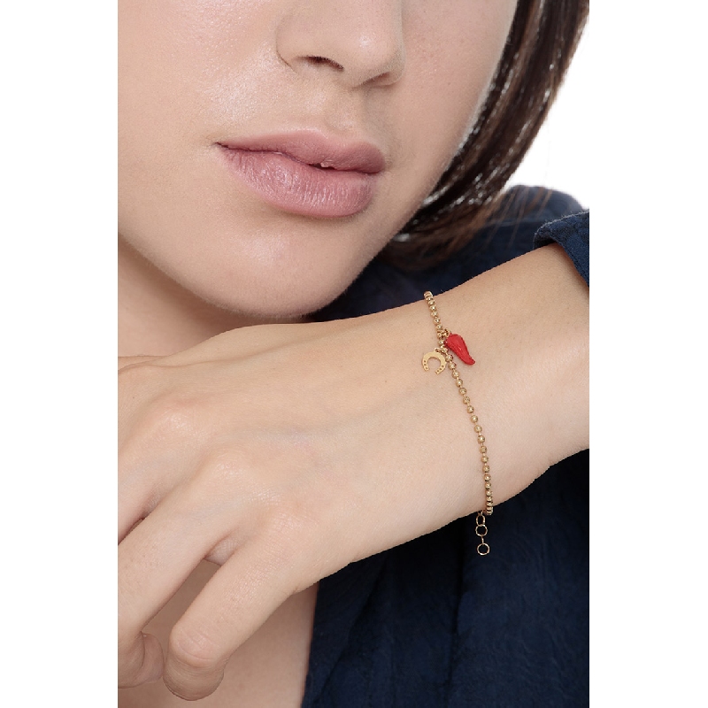 18K yellow gold bracelet with a red lucky horn and a horseshoe charm