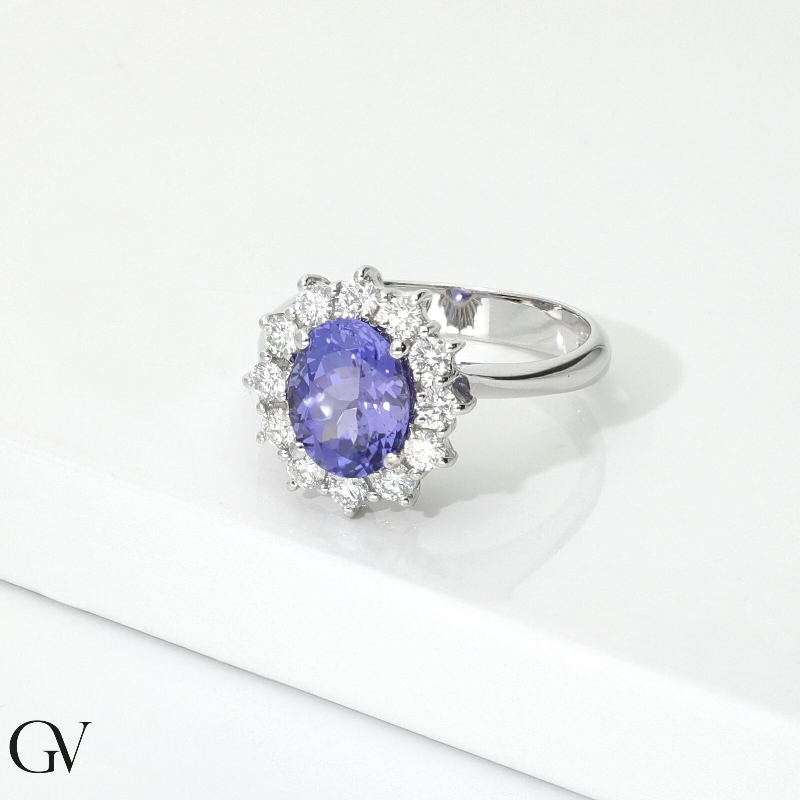 Ring in white gold 18k with central oval tanzanite and halo in diamonds Ring in white gold 18k with central oval tanzanite and halo in diamonds