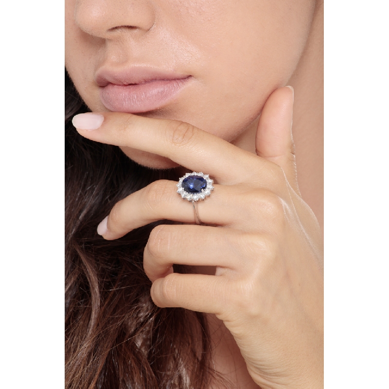 Halo ring in white gold 18k with diamonds and central blue sapphire  Halo ring in white gold 18k with diamonds and central blue sapphire