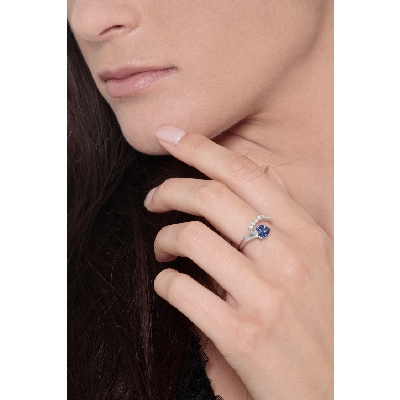 White gold ring with blue sapphire heart cut and a row of diamonds 