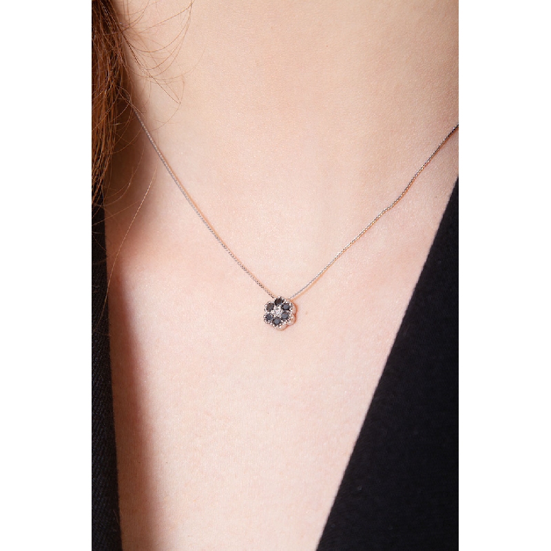 18k white gold flower pendant with black and white diamonds 18k white gold flower pendant with black and white diamonds