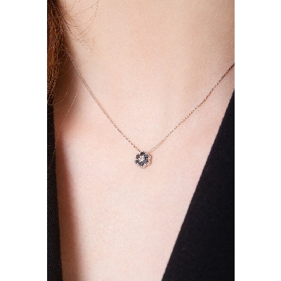 18k white gold flower pendant with black and white diamonds