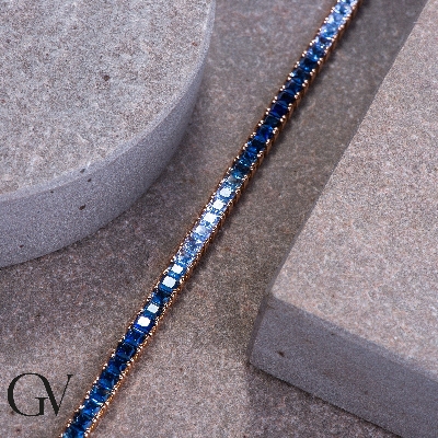 Fancy 18k rose gold tennis bracelet with blue sapphires