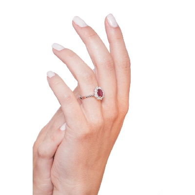 Halo ring with a central oval cut ruby and diamonds white gold 18k