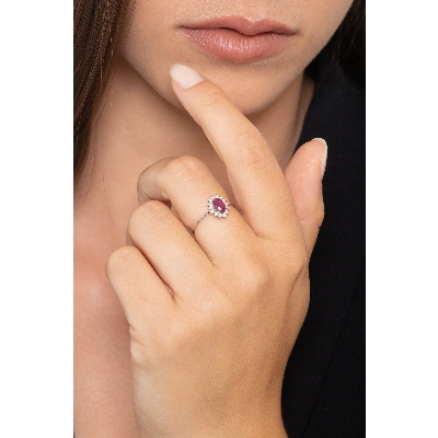 Halo ring with ruby oval cut and diamonds in white gold 18k
