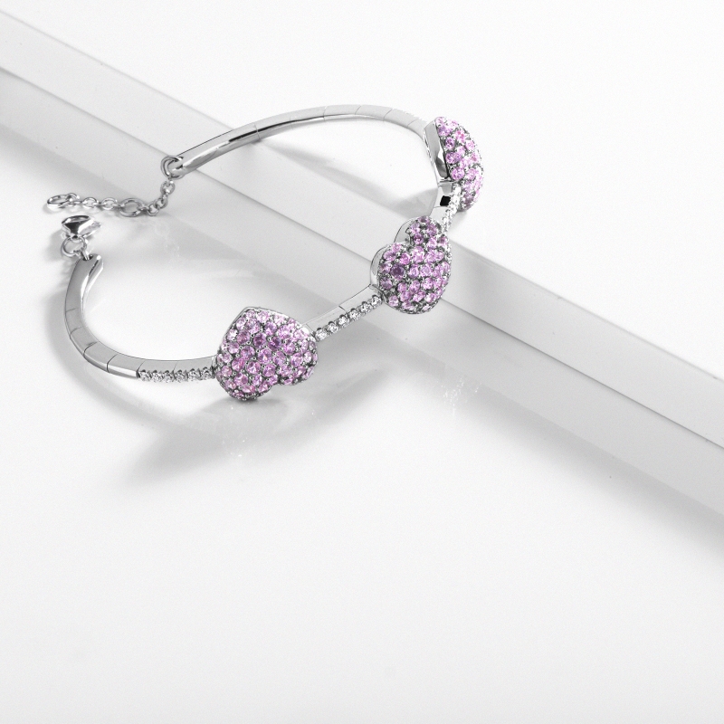 Bracelet in white gold 18k with diamonds and three hearts in pink sapphires Bracelet in white gold 18k with diamonds and three hearts in pink sapphires