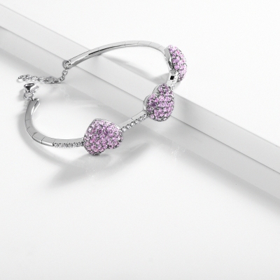Bracelet in white gold 18k with diamonds and three hearts in pink sapphires