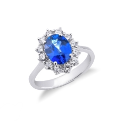 Halo ring with diamonds and blue sapphire oval cut in 18k white gold