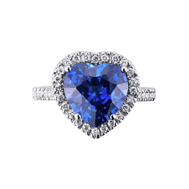 White gold 18k halo ring with a heart cut blue sapphire and diamonds shoulder set White gold 18k halo ring with a heart cut blue sapphire and diamonds shoulder set
