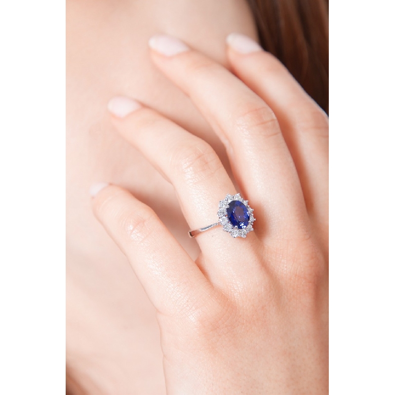 Halo ring with diamonds and blue sapphire oval cut in 18k white gold  Halo ring with diamonds and blue sapphire oval cut in 18k white gold