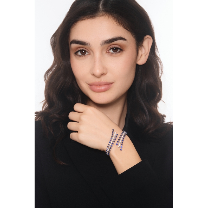 Bypass semi-rigid diamond and blue sapphire bracelet.