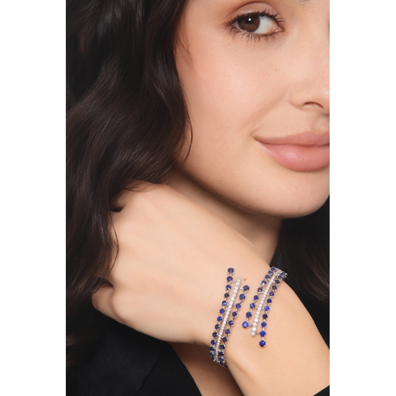 Bypass semi-rigid diamond and blue sapphire bracelet.