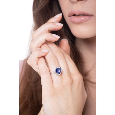 White gold 18k halo ring with a heart cut blue sapphire and diamonds shoulder set
